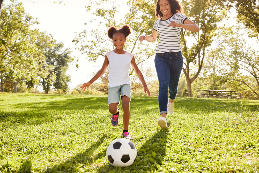 Mother and Daughter Playing Soccer