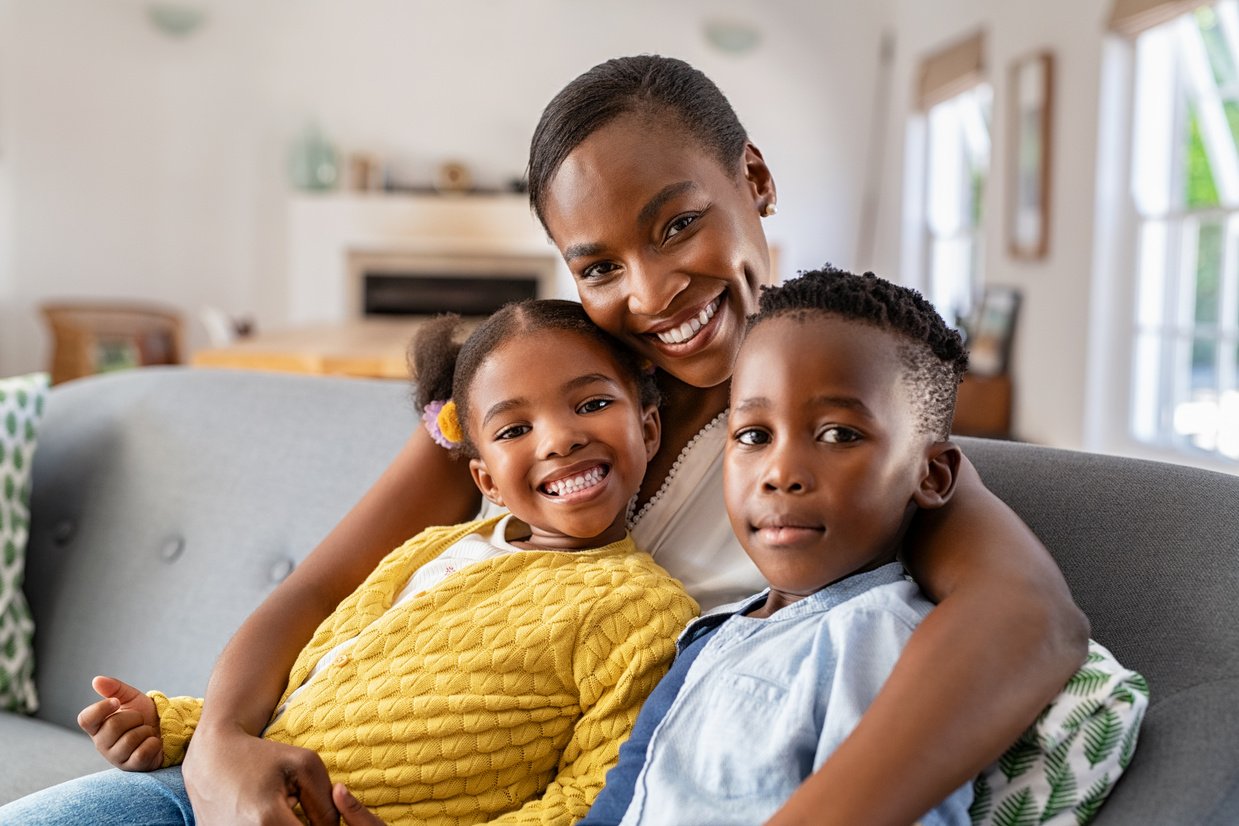 Adult with Children Sitting on Couch